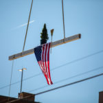 The beam being carried with an American flag, tree, and broom