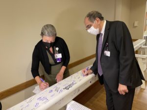 Dr. Sahel signing the beam.