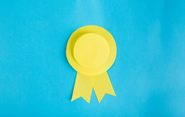 yellow paper cut out ribbon on light blue background