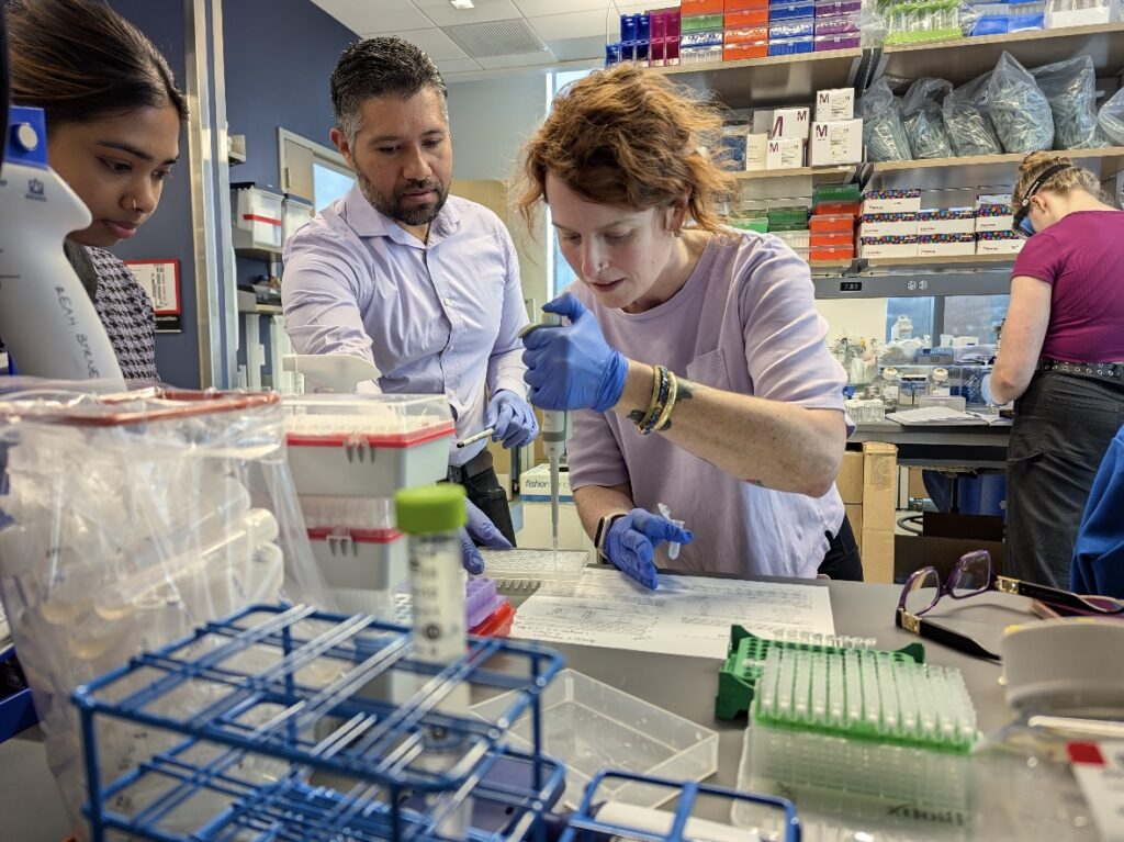 Elizabeth Wood in the lab with someone overseeing her work