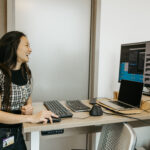 Xing Chen smiling while at computer