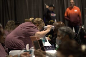 Mission of Mercy volunteer checking someone's eyes