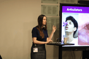 Dr. Chloe Santa Maria speaking at the first vocal education day