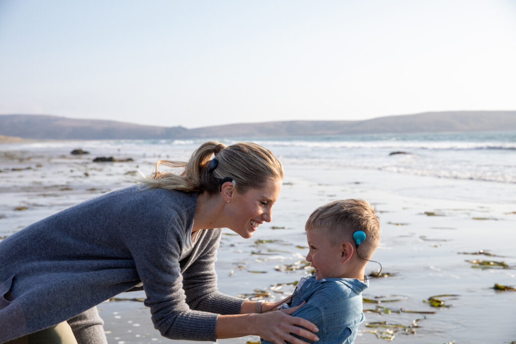 mother and son CI recipients on the beach