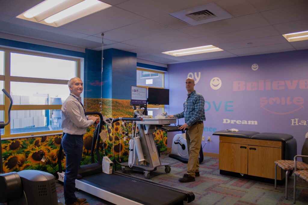 Ray and Paul by a treadmill at Children's