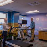 Ray and Paul by a treadmill at Children's