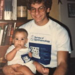 Colin as a baby being held by his dad