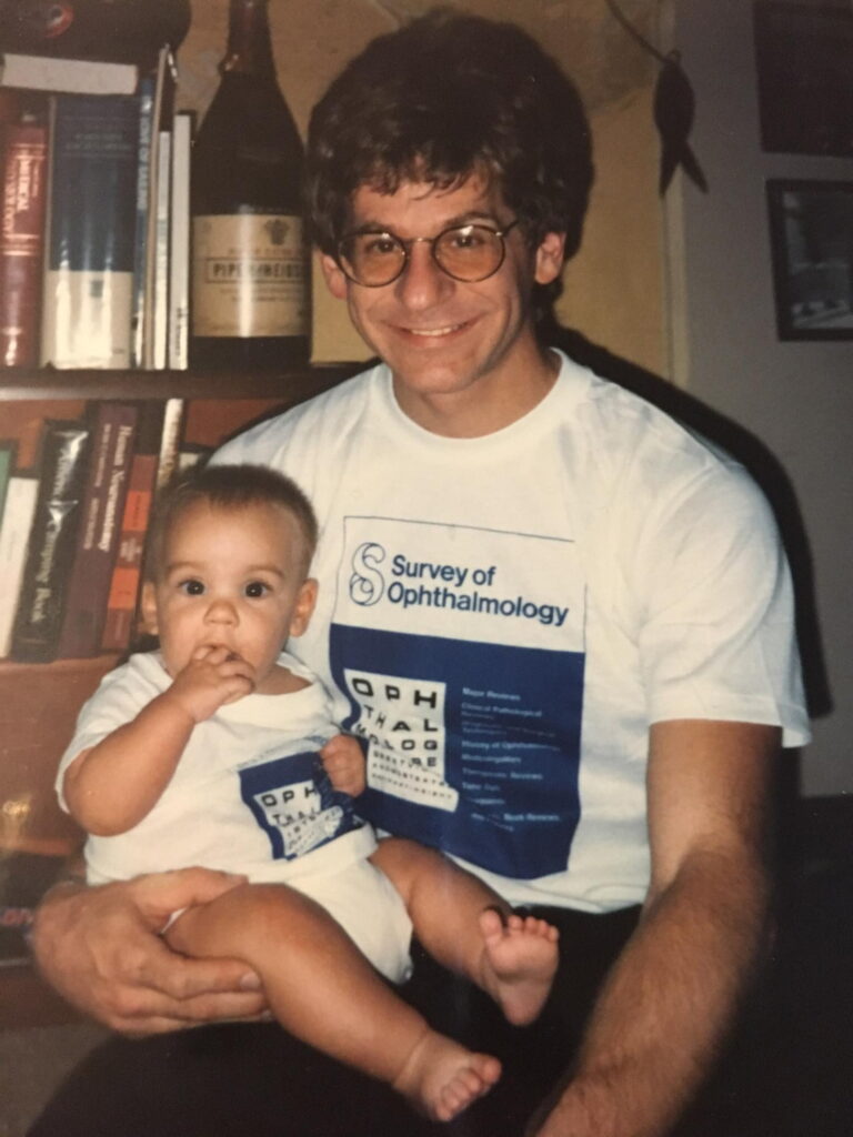 Colin as a baby being held by his dad