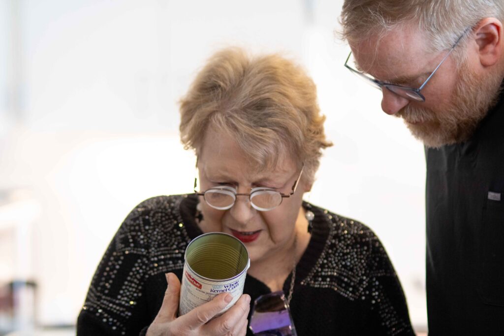 Patty reading a can with Dr. Smith looking on