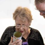 Patty reading a can with Dr. Smith looking on