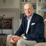 Marty McGuinn sitting on a chair in a living room