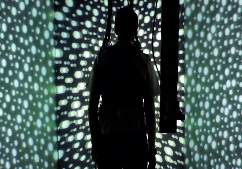 person in room with moving LED dots