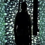 person in room with moving LED dots
