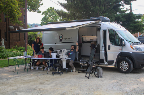 eyeVan on site, with one of the staff members waving